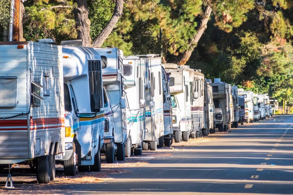 Line of RVs being used as homes parked on street in Mountain View, California.